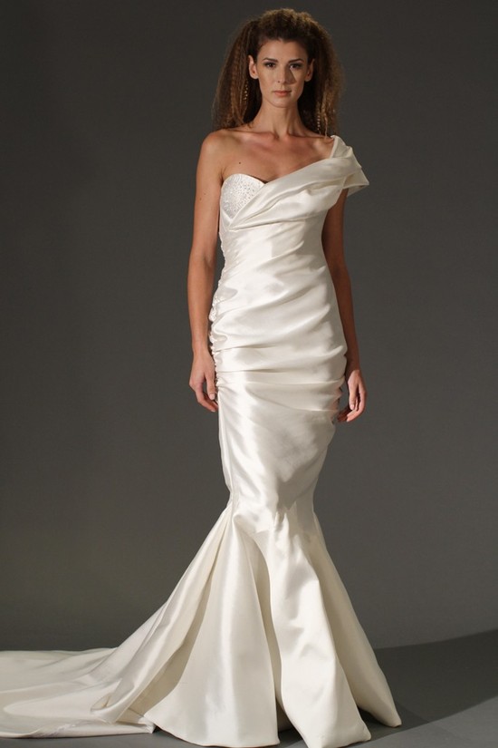 Dramatic mermaid wedding dress with deep sweetheart neckline and oversized bow