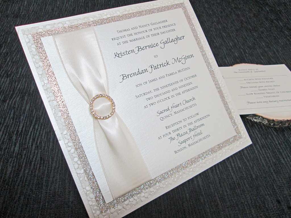 Elaborate invitation with ribbon and rhinestone brooch