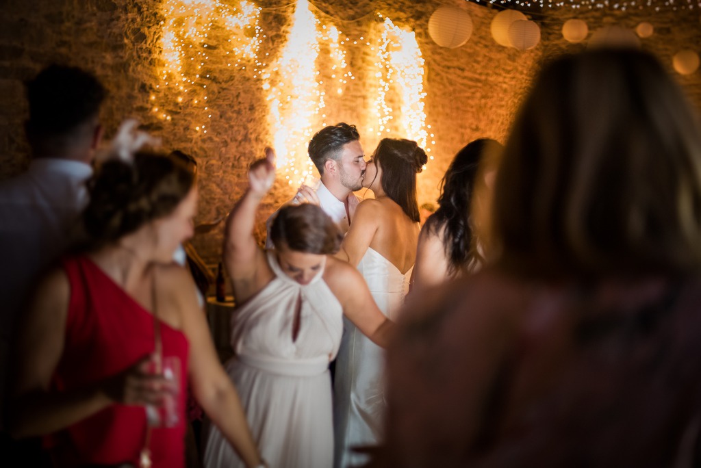 Wedding couple kissing on dancefloor
