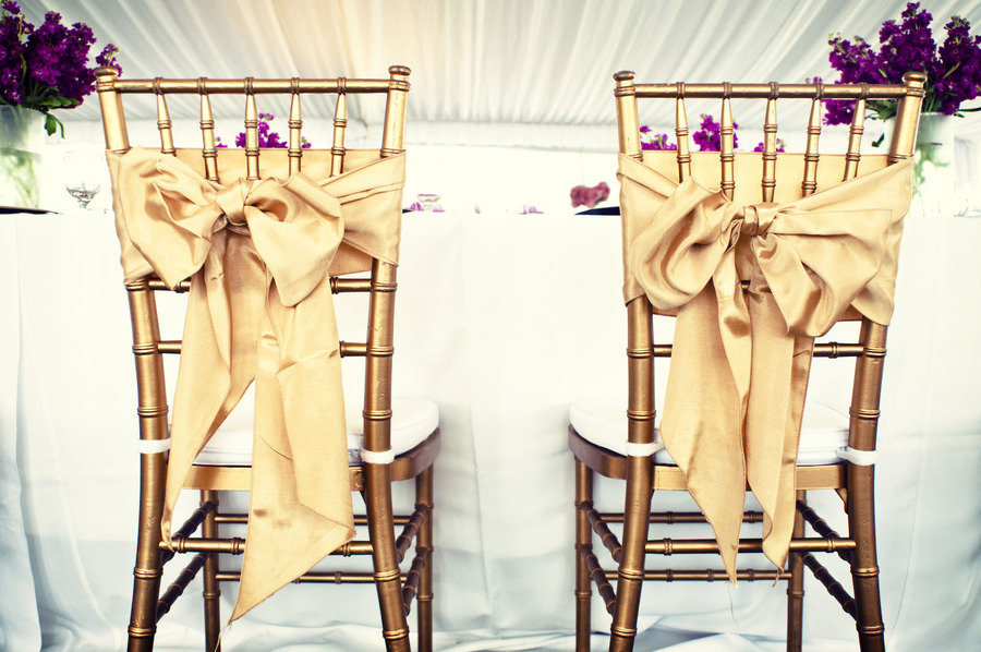 elegant wedding reception bride groom chairs gold bows