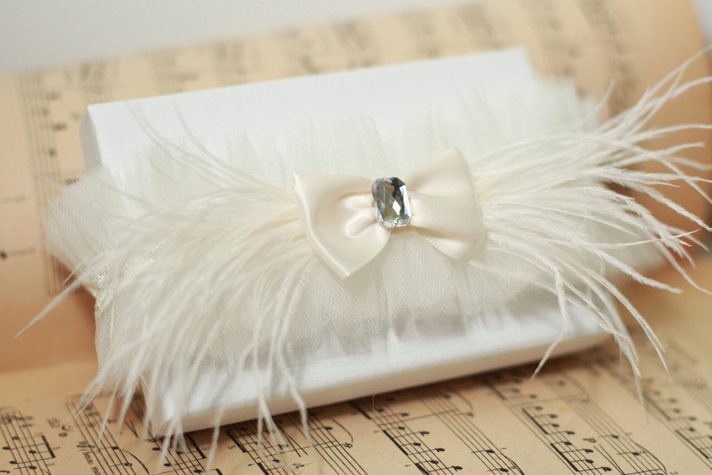 feather adorned bridal clutch with bow